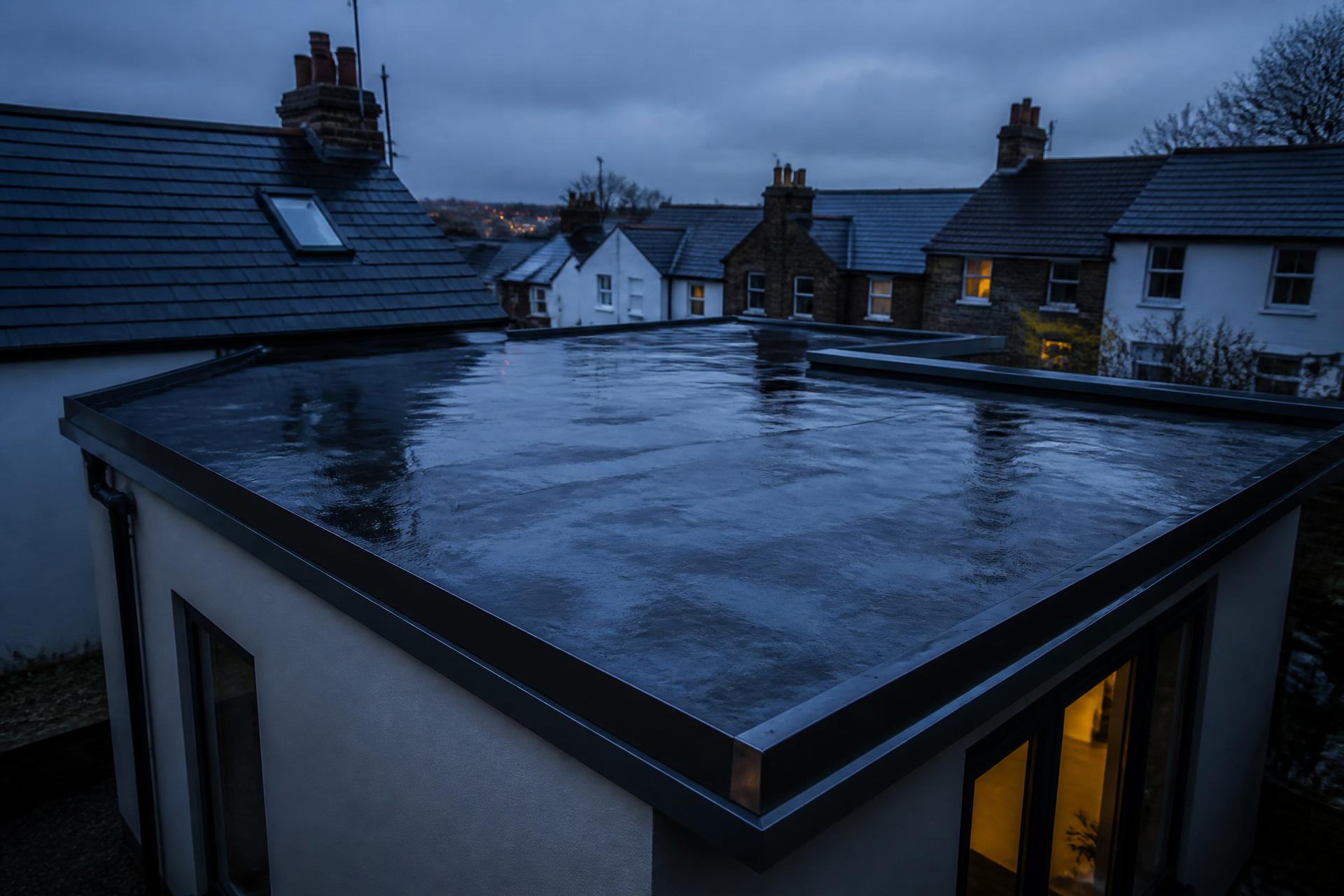 Newly installed flat roof on a UK house extension at dusk